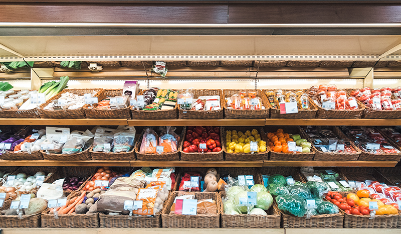 Fresh vegetables on refrigerator shelf in supermarket